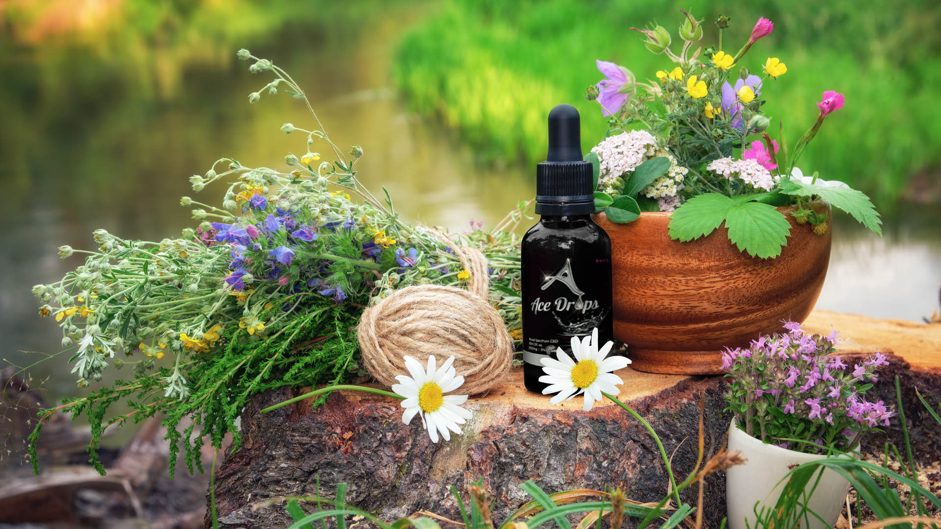 Ace Drops All Natural Premium CBD Broad Spectrum Berry Flavored Tincture Bottle 0% THC with Flowery Backdrop